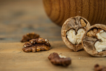 bowl full of delicious and fresh walnuts on an old wooden table