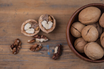 bowl full of delicious and fresh walnuts on an old wooden table