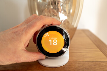 Shallow focus of the OLED display or a smart wireless central heating thermostat seen being...