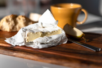 Closeup shot of camembert cheese on the cutting board