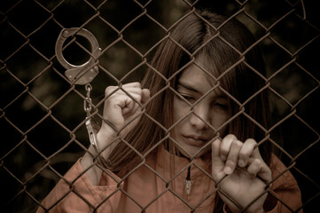 Portrait of women desperate to catch the iron prison,prisoner concept,thailand people,Hope to be...