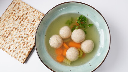 Jewish chicken broth with kneidlach (balls made with matzo meal)Matzo ball soup