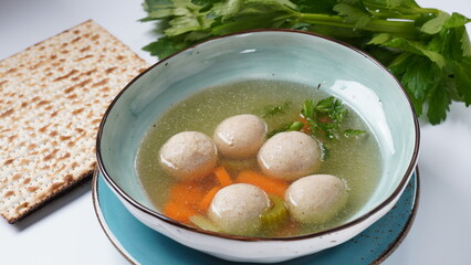 Jewish chicken broth with kneidlach (balls made with matzo meal)Matzo ball soup