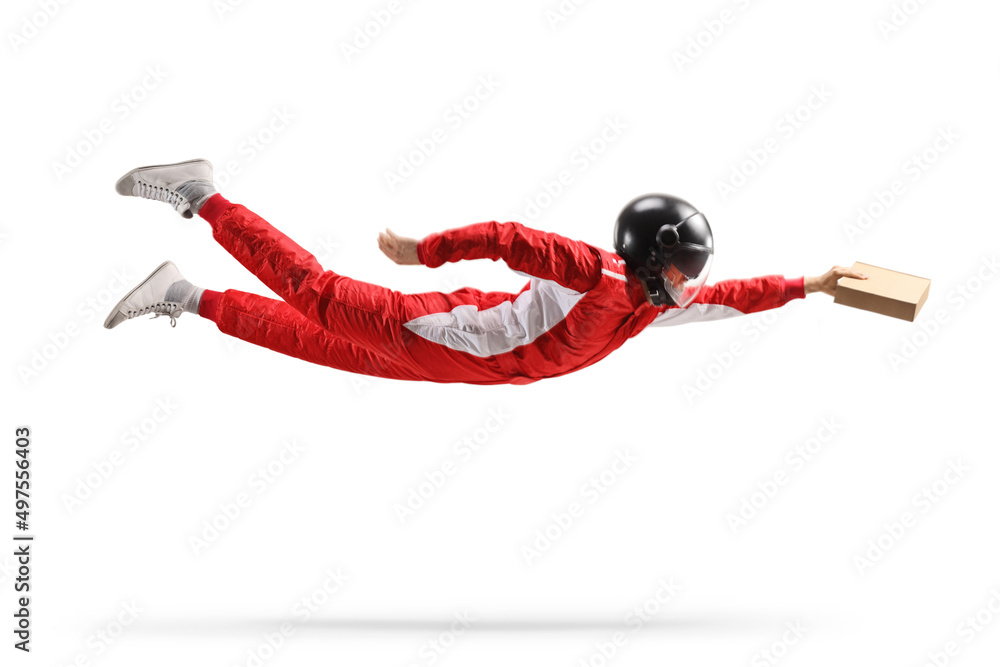 Wall mural racer in a red suit and a helmet flying and carrying a cardboard package