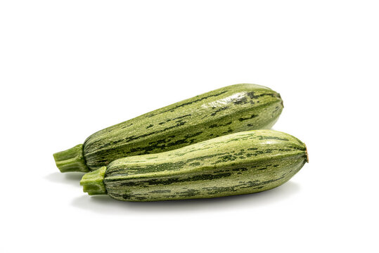 Fresh cut zucchini isolated on a white background with clipping path. Design element for product label. Design image of fresh whole zucchini. Green zucchini vegetables isolated on white.