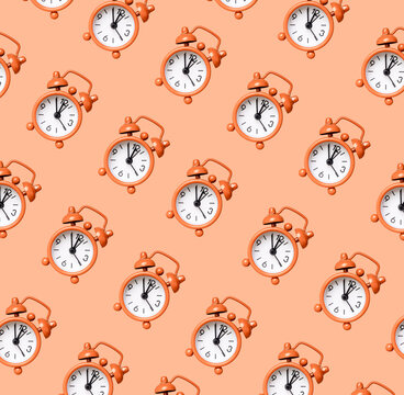 Retro alarm clock pattern on coral background. Time, accuracy concept. High quality photo