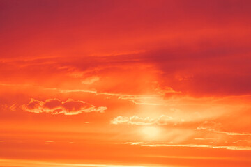 Vivid, bright and colorful background of red, orange and yellow morning or evening sky during sunrise or sunset