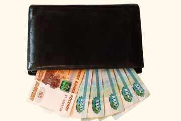 Paper Russian money of various denominations lies in the portmon