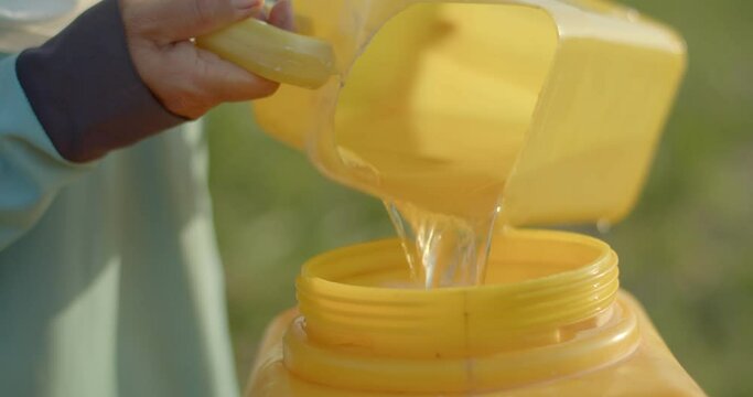 Farmers add pesticides to the syringe tank to prepare for injection on the farm.