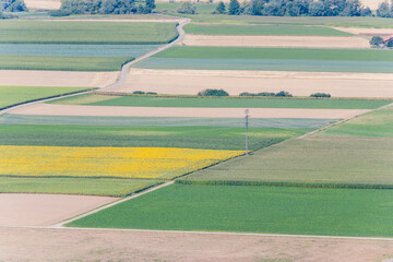 View of rural area with freshly cultivated fields on a sunny spring day