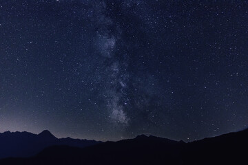 Milky way Stars in the night sky with silhouettes of mountains in the background