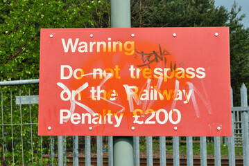 Old Red Warning Sign with Painted Graffiti
 - obrazy, fototapety, plakaty