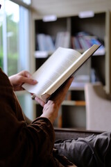 person reading a book. library