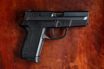 9mm Handgun on Leather Background
