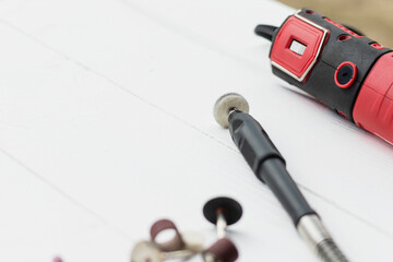 dremel. precise and accurate processing of the product. on a wooden background in retro style. white color