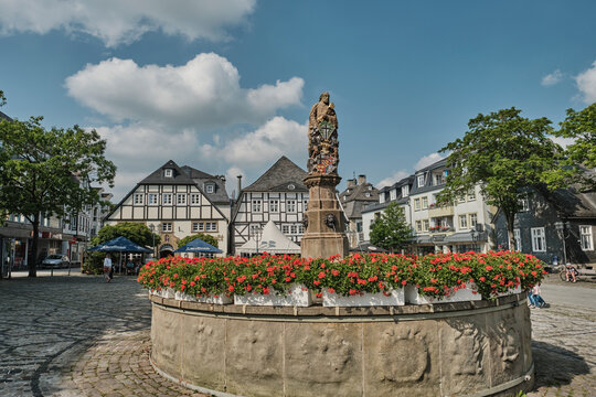 Old fountain with sculpture in Brilon city center