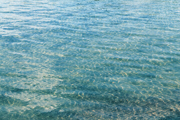 Abstract rippled clear water, rocky bottom defocus