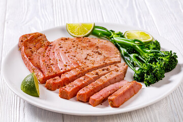 fried tuna steak with boiled broccolini and lime