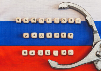 The words sanctions against Russia are written from wooden cube letters.