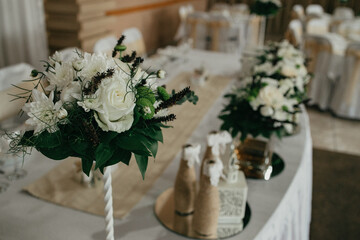 Table decoration for a special occasion - white plates and green plants. Eco/nature friendly decoration. 