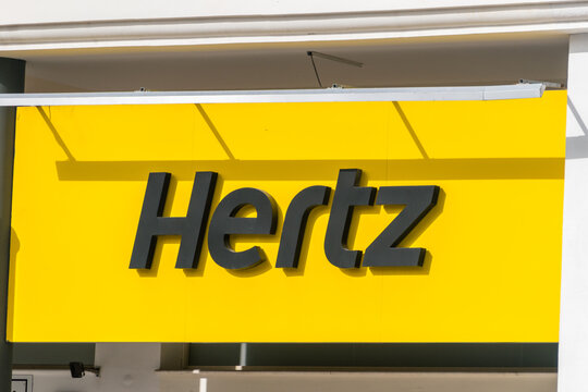Paphos, Cyprus - April 2, 2022: Logo and sign of Hertz Corporation, a subsidiary of Hertz Global Holding.