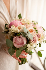 Beautiful bright bouquet of the bride of roses. Wedding paraphernalia