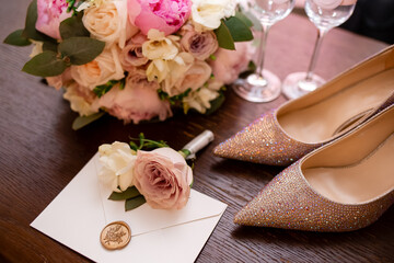 The concept of wedding paraphernalia and details: envelope, bride's bouquet, shoes, boutonniere,...