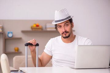 Young man preparing for trip at home