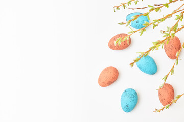 Branches with buds and green leaves, easter eggs on a white background. Happy easter concept with copy space