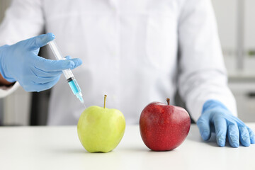 Scientist makes injection in apple in laboratory