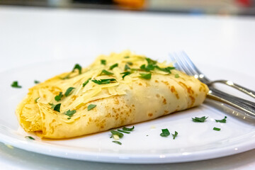 Russian pancakes with stuffing and sprinkled with grated cheese