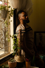 Portrait of a young african american male plant enthusiast thinking about the environment 