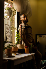 Portrait of young black male plant enthusiast at home 