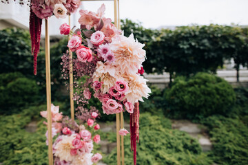Wedding arch made of fresh pink flowers. Wedding scenery