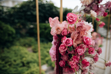 Pink roses on the wedding arch at the wedding ceremony