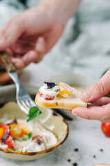 Mix tomatoes with capers and tuna cream. Tomato menu in a restaurant. Tasting dishes close-up. Snack on toast