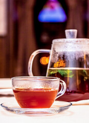 Glass teapot with tea brewed with herbs and berries