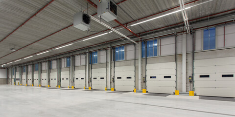 Interior of a new empty warehouse with loading docks ready to be used