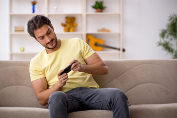 Young man sitting at home during pandemic