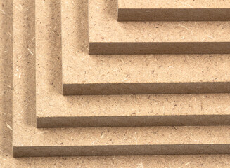Multiple boards of raw MDF brown in close-up.