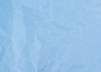 Wrinkled sheet of light blue paper. Textured backdrop