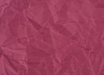Wrinkled sheet of wine red paper. Textured backdrop