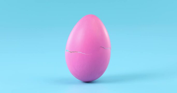 Pink Easter egg slowing cracking and breaking apart time lapse.