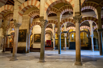 Fototapeta premium Medieval moorish architecture, colorful achways with columns in old mosque in Cordoba with no people, Andalusia, Spain