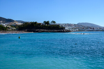 Fototapeta na wymiar All year sun vacation destination, blue ocean water on beach Playa del Duque in Costa Adeje, Tenerife island, Canary, Spain