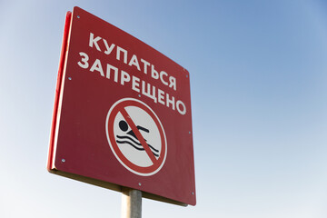 Swimming is prohibited, red sign with Russian text