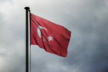 Flag of Turkey is under stormy sky