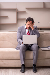 Young male employee working from home during pandemic