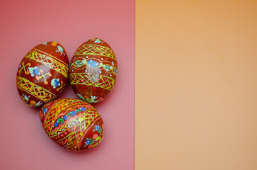wood painted colorfull easter eggs on red-yellow background