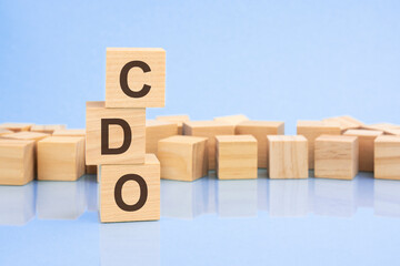 on a bright blue background, light wooden blocks and cubes with the text CDO